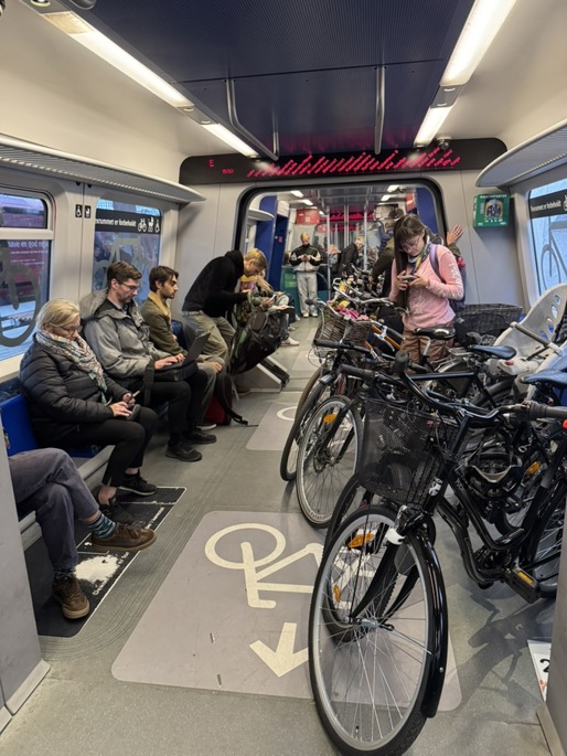 A group of people sitting on a train

AI-generated content may be incorrect.